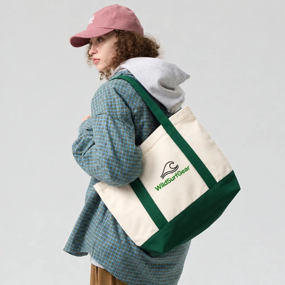 Person carrying WildSurfGear heavy canvas tote bag over shoulder