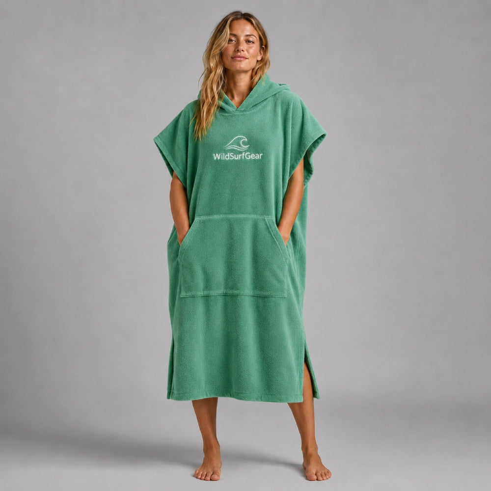 Full-length front view of a green cotton surf poncho with hood and kangaroo pocket